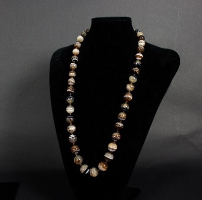 Lot 160 - A banded agate bead necklace of forty-four...