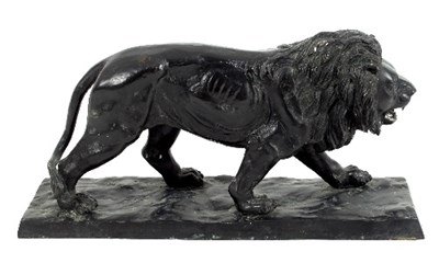 Lot 179 - A cast metal figure of a pacing lion on a...