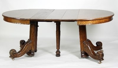 Lot 456 - An oak extending dining table with heavy...