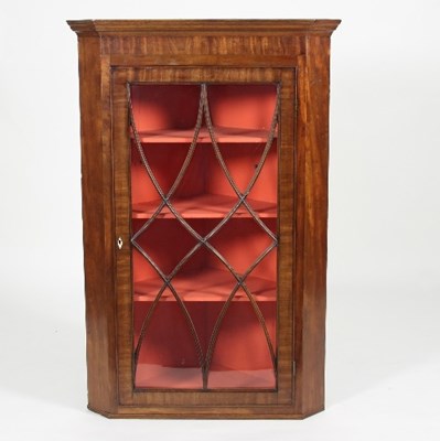 Lot 518 - A George III mahogany corner cupboard enclosed...