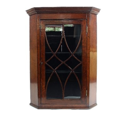 Lot 554 - An early 19th Century oak corner cupboard,...