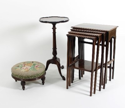 Lot 556 - A nest of four mahogany tables, a footstool...