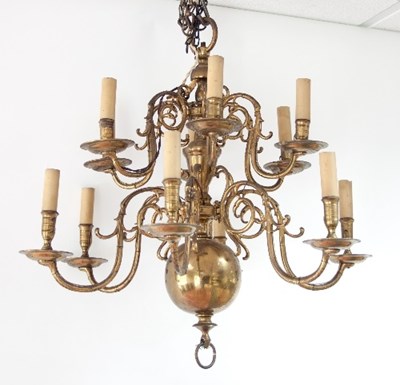 Lot 576 - A Dutch brass twelve-light chandelier with two...