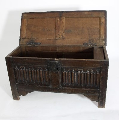 Lot 578 - An oak coffer with single panel top and linen...