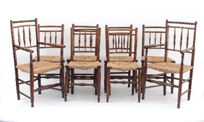 Lot 580 - A set of eight spindle back rush seat dining...