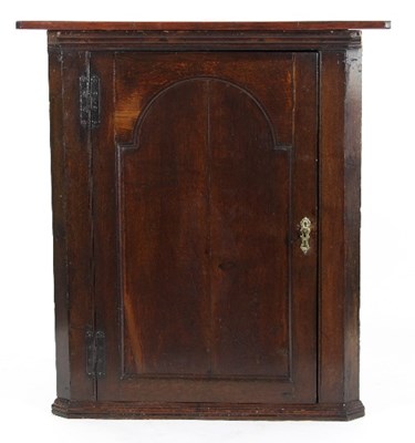 Lot 582 - An early 19th Century oak corner cupboard,...