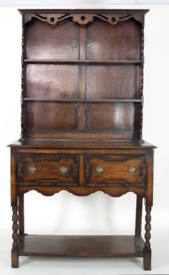 Lot 586 - An oak dresser with shelves over, the base...