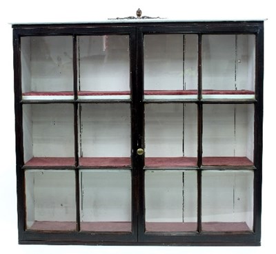 Lot 590 - A painted pine cupboard enclosed by a pair of...