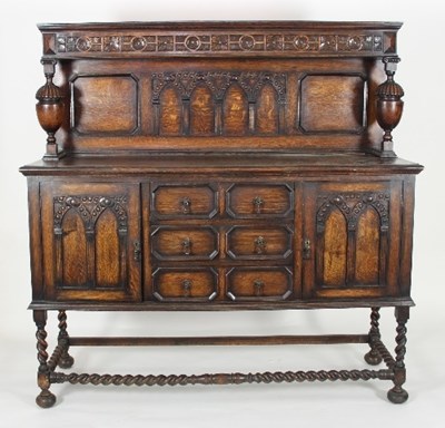 Lot 593 - An oak sideboard with drawers and cupboards on...