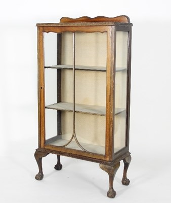 Lot 606 - A 1930s walnut display cabinet on cabriole...