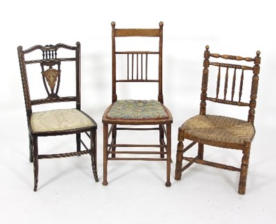 Lot 608 - A rush seat spindle back chair on turned legs...