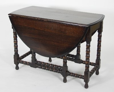 Lot 612 - An oak gateleg table on bobbin turned supports,...