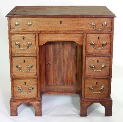 Lot 633 - A George III mahogany kneehole desk fitted one...