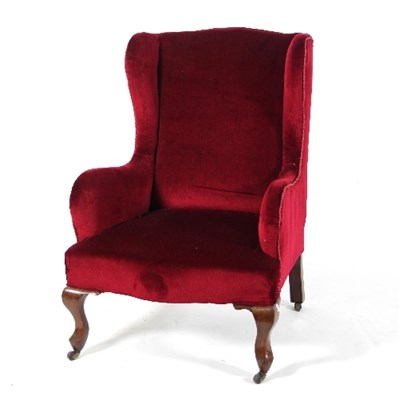 Lot 637 - A walnut wing armchair with cabriole front...