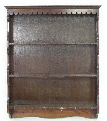 Lot 648 - A set of oak wall shelves with scalloped apron...