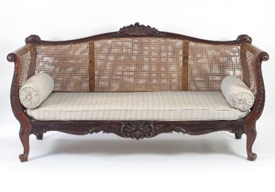 Lot 676 - A Louis XV style walnut and caned canape,...