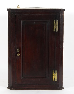 Lot 682 - An early George III mahogany corner cabinet,...