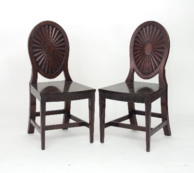 Lot 690 - A pair of George III mahogany hall chairs, in...