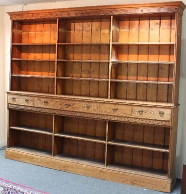 Lot 711 - A large pitch pine bookcase, the upper section...