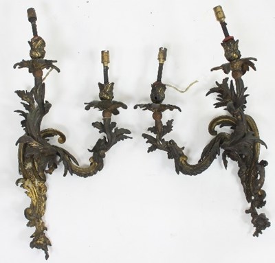 Lot 713 - A pair of two-branch gilt metal wall lights,...