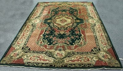 Lot 753 - A modern carpet, the central cartouche on a...