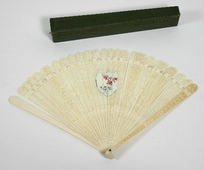 Lot 762 - A pierced ivory fan with central shield shaped...