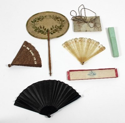 Lot 763 - A black moire© silk fan with black sticks, a...