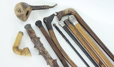 Lot 777 - A group of walking canes and pipes, to include...