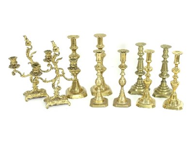 Lot 788 - Four pairs of baluster brass candlesticks and...