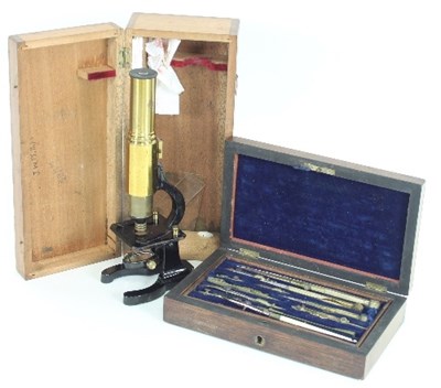 Lot 819 - A student's microscope, 24ch high, in a fitted...