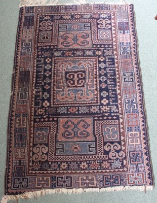 Lot 6 - An Eastern blue ground rug, with geometric...