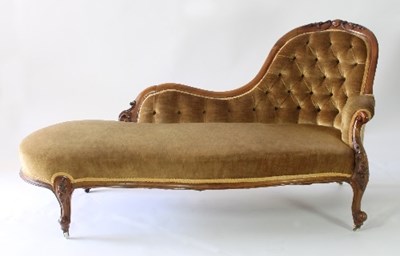 Lot 12 - A Victorian walnut framed chaise longue, the...