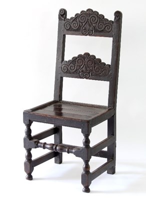 Lot 20 - A 17th Century oak chair, the carved arched...