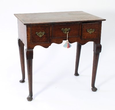 Lot 23 - A George III oak lowboy, fitted three drawers...