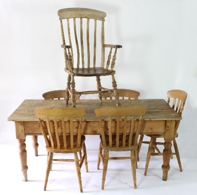 Lot 28 - A pine farmhouse dining table with five pine...