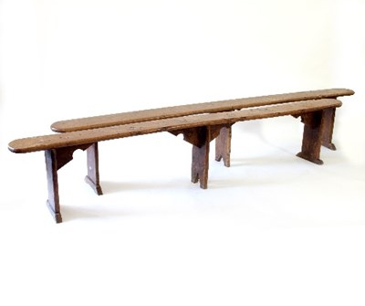 Lot 71 - A pair of elm benches, on three uprights with...