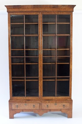 Lot 93 - A burr walnut standing bookcase enclosed by a...