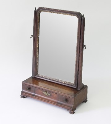 Lot 99 - A Georgian mahogany dressing mirror on a three-...