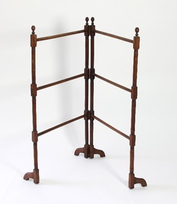 Lot 101 - A folding towel rail on turned supports and...