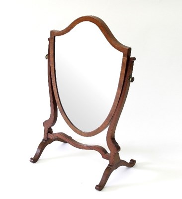 Lot 104 - A mahogany shield shaped toilet mirror on a...