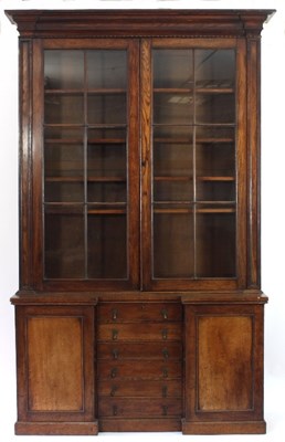 Lot 107 - A late Regency oak bookcase, the moulded...