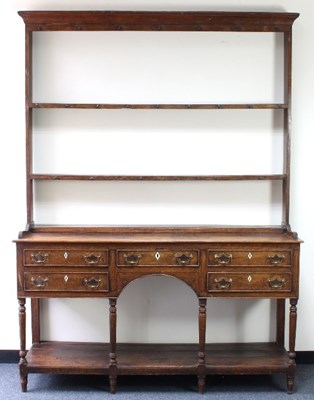 Lot 116 - A late 18th Century oak dresser, the open rack...