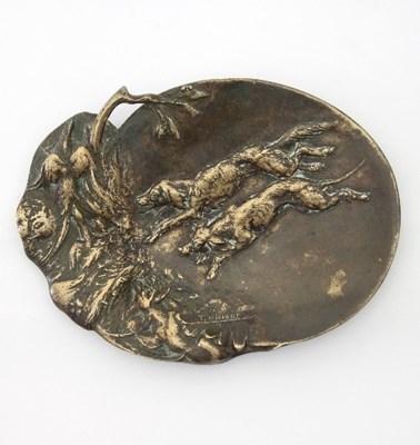 Lot 151 - A bronze pin tray decorated in relief with two...