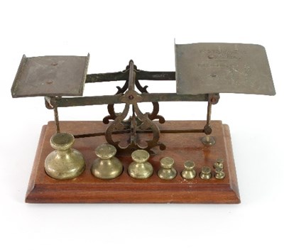 Lot 169 - A set of brass postal scales with eight...