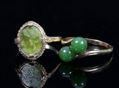 Lot 460 - A jade crossover two-stone dress ring to a...