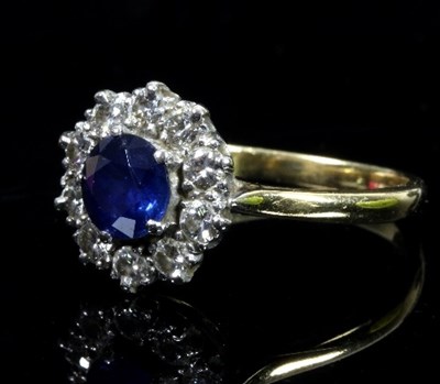 Lot 461 - A sapphire and diamond cluster ring, the...