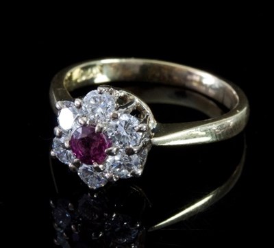 Lot 480 - A ruby and diamond cluster ring, the ruby to a...