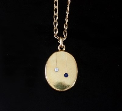 Lot 487 - An oval gold locket set with a diamond and...