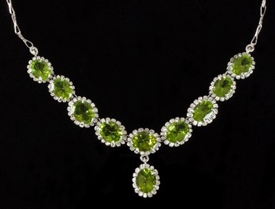 Lot 492 - A peridot necklace centred by a line of nine...