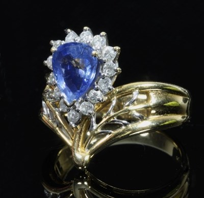 Lot 503 - A sapphire and diamond cluster ring, the pear...